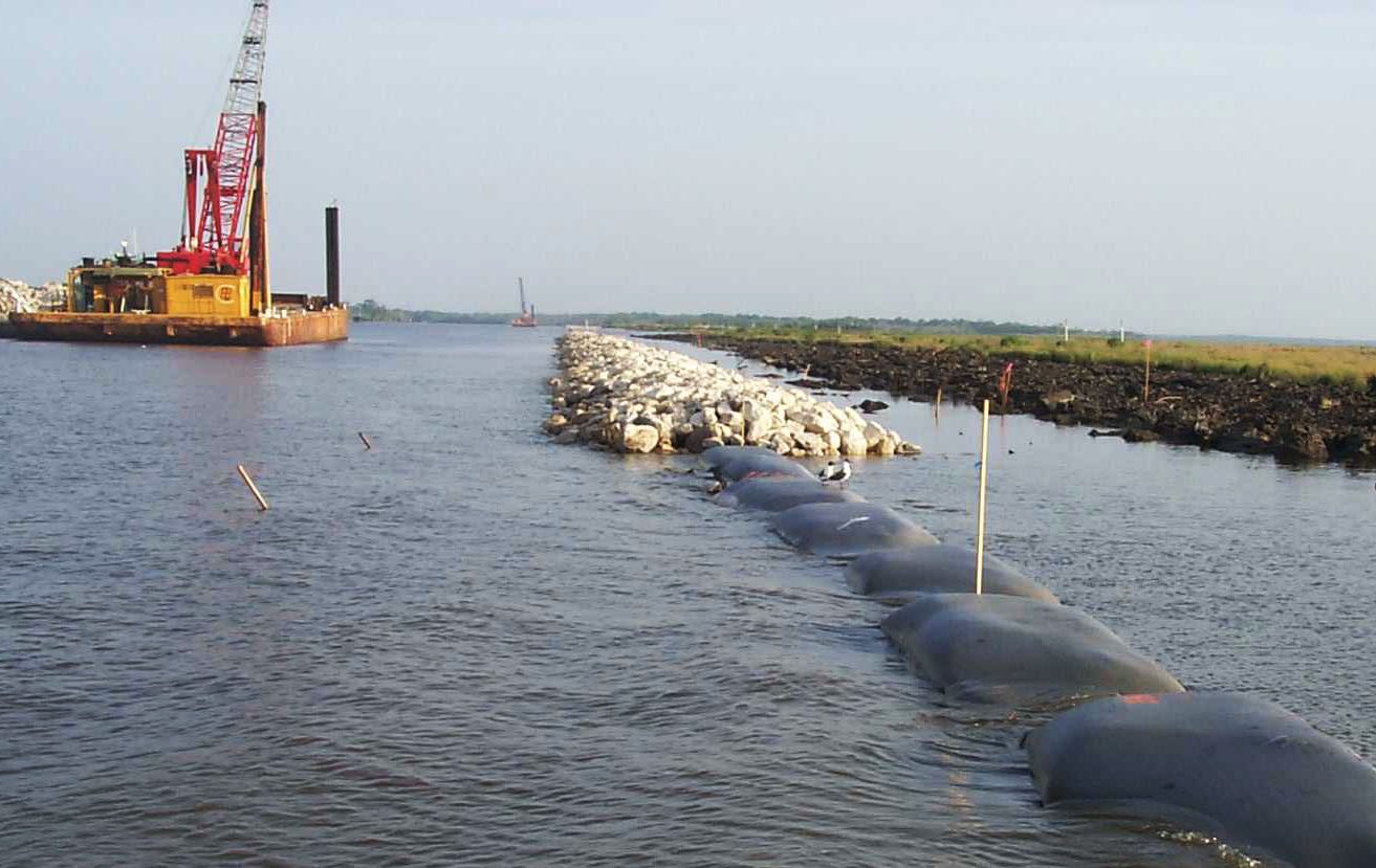 Geotextile fabric bags were filled with lightweight aggregate, supporting the shoreline stabilization structure.