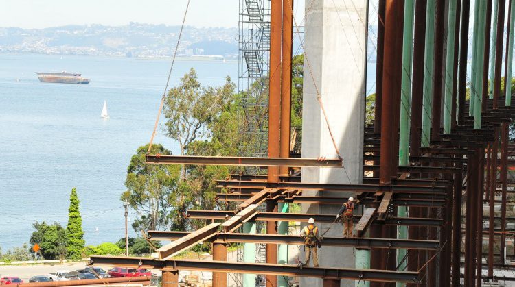 The falsework erection shows the tie-downs needed to combat heavy winds.